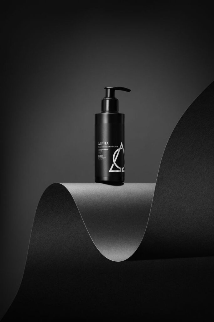 High-end product photography for ads showing a premium skincare bottle on minimalist black background.